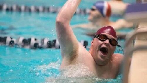 Sports-Travel-Magazine-Story Image of a male Special Olympics athlete coming out of a swimming pool